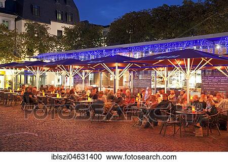 Stock Image - Outdoor catering at Münsterplatz in the evening, Bonn, North Rhine-Westphalia, Germany, Europe. Fotosearch