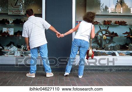 Stock Image - Pair different direction shop window, Berlin, Germany, Europe. Fotosearch