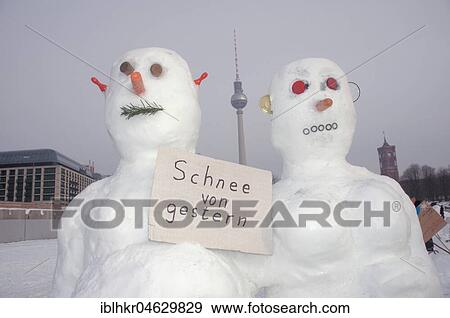 Stock Photo - Pair of snowmen with a sign snow from yesterday on the snowman demo against global warming in front of the Berlin Cathedral against global warming, Humboldtforum, Schlossplatz, Mitte, Berlin, Germany, Europe. Fotosearch