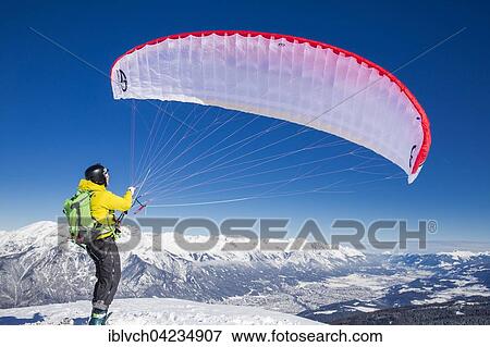 Paraglider, man preparing glider for takeoff, Axamer Lizum, Innsbruck, Tyrol, Austria, Europe View Large Photo Image Stock Photo - Paraglider, man preparing glider for takeoff, Axamer Lizum, Innsbruck, Tyrol, Austria, Europe. Fotosearch