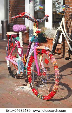 Parked colourful bicycle, crocheted around, in the pedestrian zone, Leer, East Frisia, Lower Saxony, Germany, Europe View Large Photo Image Stock Photo - Parked colourful bicycle, crocheted around, in the pedestrian zone, Leer, East Frisia, Lower Saxony, Germany, Europe. Fotosearch