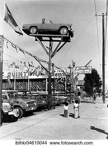 Picture - People gazing at car in the air, Mexico City, Mexico, Central America. Fotosearch