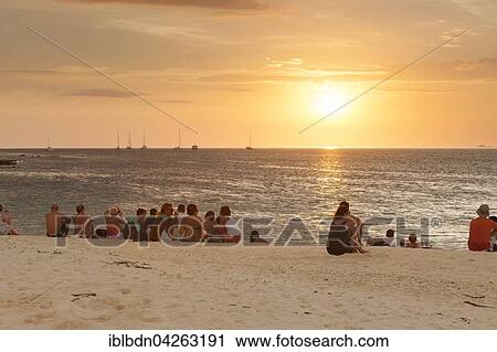 Stock Image - People watching the sunset on Ko Lipe or Koh Lipe island, Tarutao National Marine Park, Thailand, Asia. Fotosearch