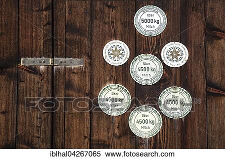 Stock Photography - Plaques for the milk yield of cows, on a barn at Bruck, Allgau, Bavaria, Germany, Europe. Fotosearch