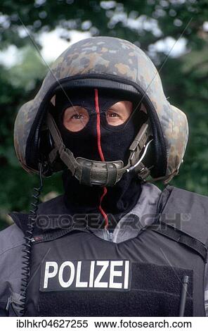 Stock Photography - Police officer with helmet, mask and bulletproof vest, Berlin, Germany, Europe. Fotosearch