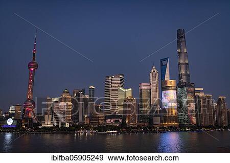 Stock Photo - Pudong Area, Special Economic Zone, Municipality of Shanghai, on the eastern bank of Huang Po River, at night the buildings are illuminated, left the Oriental Pearl Tower from the center of the Shanghai Tower, Shanghai, China, Asia. Fotosearch