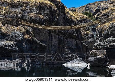 Stock Image - Qu'eswachaka suspension bridge, rope bridge made of woven Peruvian Feathergrass (Stipa ichu), over the Apurimac River, last known working Inca suspension bridge, national cultural heritage of Peru, Southern Peru, Peru, South America. Fotosearch