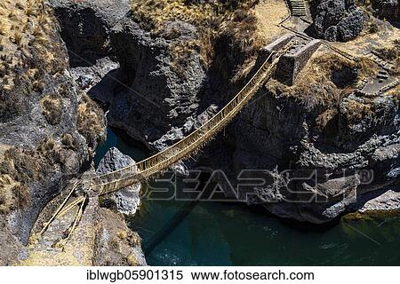 Stock Photography - Qu'eswachaka suspension bridge, rope bridge made of woven Peruvian Feathergrass (Stipa ichu), over the Apurimac River, last known working Inca suspension bridge, national cultural heritage of Peru, Southern Peru, Peru, South America. Fotosearch