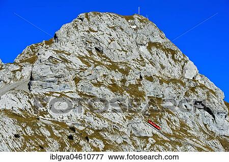 Red railcar of the Pilatus Railway on the steep railway line at Mount Pilatus, Alpnachstad, Switzerland, Europe View Large Photo Image Stock Photo - Red railcar of the Pilatus Railway on the steep railway line at Mount Pilatus, Alpnachstad, Switzerland, Europe. Fotosearch
