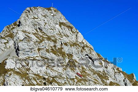 Stock Photo - Red railcar of the Pilatus Railway on the steep railway line at Mount Pilatus, Alpnachstad, Switzerland, Europe. Fotosearch