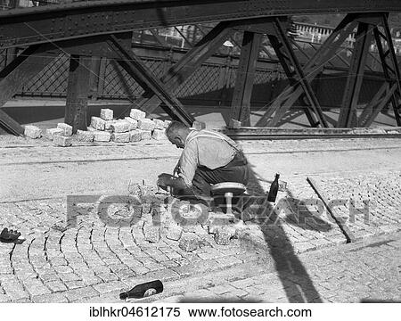 Road worker paving a road with natural stones, Freiburg ca. 1945 to 1955 View Large Photo Image Stock Photography - Road worker paving a road with natural stones, Freiburg ca. 1945 to 1955. Fotosearch