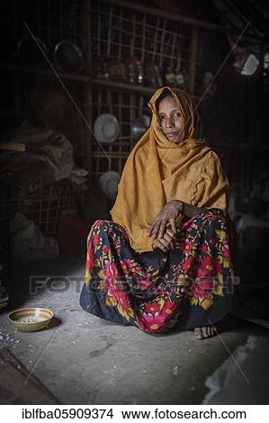 Picture - Rohingya woman in her hut in Kutupalong camp, Cox Bazaar, Bangladesh, Asia. Fotosearch