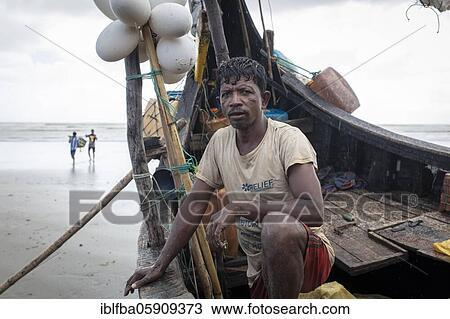 Stock Image - Rohingya, works for fishermen on the beach of Cox Bazaar, Bangladesh, Asia. Fotosearch