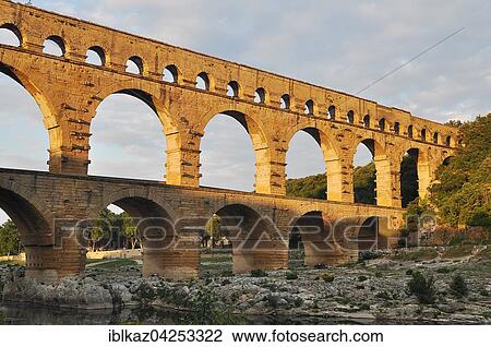 Roman aqueduct Pont du Gard over the Gardon in the evening, Remoulins, Provence, Southern France, France, Europe View Large Photo Image Stock Image - Roman aqueduct Pont du Gard over the Gardon in the evening, Remoulins, Provence, Southern France, France, Europe. Fotosearch