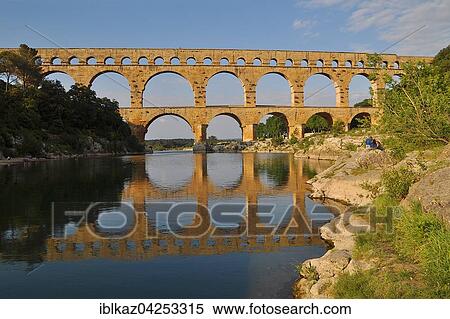 Roman aqueduct Pont du Gard reflected in the Gardon river, Remoulins, Provence, Southern France, France, Europe View Large Photo Image Stock Photography - Roman aqueduct Pont du Gard reflected in the Gardon river, Remoulins, Provence, Southern France, France, Europe. Fotosearch