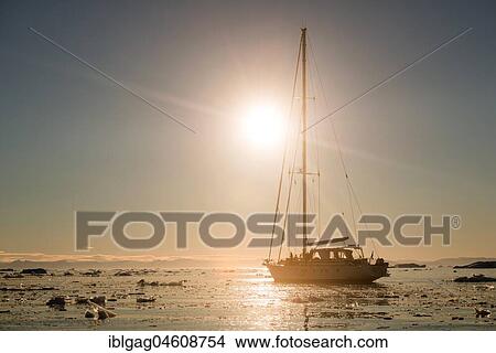 Sailing ship between ice floes in the fjord, evening light, Greenland, North America View Large Photo Image Picture - Sailing ship between ice floes in the fjord, evening light, Greenland, North America. Fotosearch