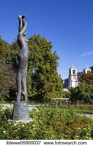 Stock Photo - Sculpture, Dancer in the Mirabell Garden with Andräkirche, Salzburg, Austria, Europe. Fotosearch