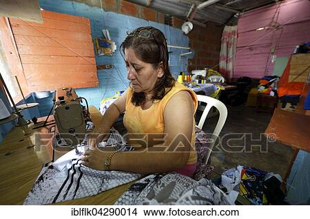 Picture - Seamstress in Comuna 8 slum, Medellin, Antioquia Department, Colombia, South America. Fotosearch