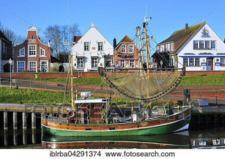 Shrimp boats in harbour in front of historical buildings, Greetsiel, Lower Saxony, Germany, Europe View Large Photo Image Picture - Shrimp boats in harbour in front of historical buildings, Greetsiel, Lower Saxony, Germany, Europe. Fotosearch
