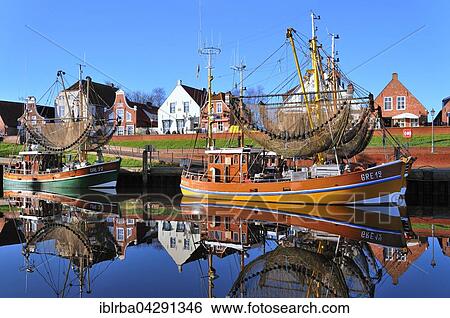Shrimp boats in harbour in front of historical buildings, Greetsiel, Lower Saxony, Germany, Europe View Large Photo Image Stock Photograph - Shrimp boats in harbour in front of historical buildings, Greetsiel, Lower Saxony, Germany, Europe. Fotosearch