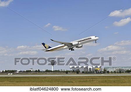 Stock Image - Singapore Airlines, Airbus A350-900, take-off, runway south, with tower and MAC Munich Airport Center in the background, Munich Airport, Upper Bavaria, Germany, Europe. Fotosearch