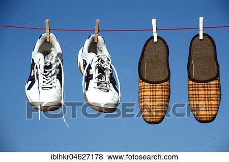 Stock Photo - Slipper Sneaker Clothesline, Berlin, Germany, Europe. Fotosearch