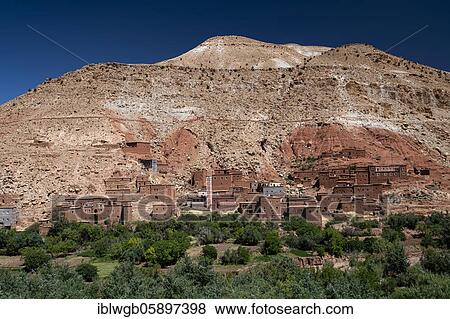 Stock Photo - Small clay village with Kasbahs, clay castles and Islamic mosque, Ait Ounila river valley, High Atlas, South Morocco, Morocco, Africa. Fotosearch