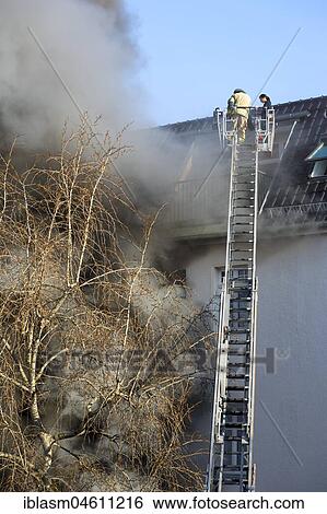 Stock Photograph - Smoke from house windows, firefighting mission with turntable ladder, Moabit, Berlin, Germany, Europe. Fotosearch