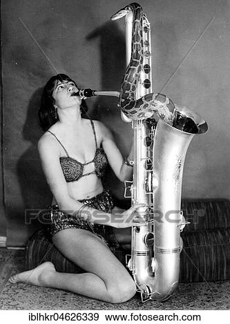 Stock Photo - Snake comes from the saxophone ca. 1955, exact location unknown, Germany, Europe. Fotosearch
