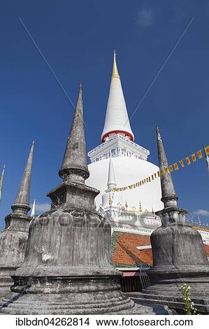 Picture - Some small chedis surrounding Phra Baromathat chedi, Wat Phra Mahathat Woramahawihan temple, Nakhon Si Thammarat, Thailand, Asia. Fotosearch