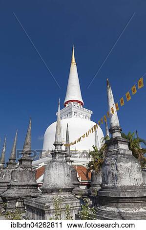 Stock Image - Some small chedis surrounding Phra Baromathat chedi, Wat Phra Mahathat Woramahawihan temple, Nakhon Si Thammarat, Thailand, Asia. Fotosearch