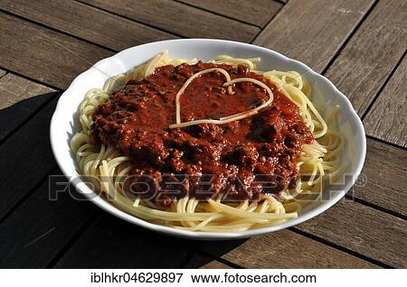 Stock Photo - Spaghetti Bolognese with heart, love goes through the stomach, Germany, Europe. Fotosearch