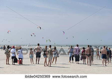 Stock Photo - Spectators on the beach, kitesurfers, Kitesurf World Cup, Sankt Peter-Ording, North Sea, North Frisia, Schleswig-Holstein, Germany, Europe. Fotosearch