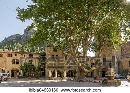 Stock Image - Square of liberty at Saint-Guilhem-le-Désert labelled Les Plus Beaux Villages de France, Herault departement, Occitanie, France, Europe. Fotosearch