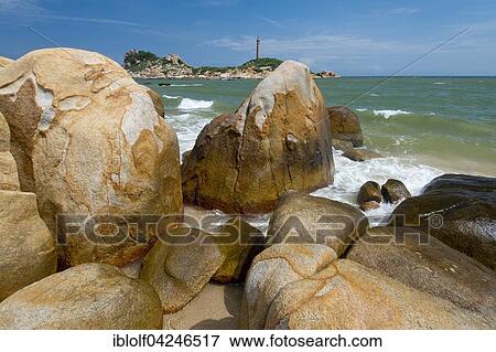 Surf at the sandstones in the bay of Ke Ga, in the back highest and oldest lighthouse in Vietnam, Phan Thiet, Ke Ga, Vietnam, Asia View Large Photo Image Stock Photo - Surf at the sandstones in the bay of Ke Ga, in the back highest and oldest lighthouse in Vietnam, Phan Thiet, Ke Ga, Vietnam, Asia. Fotosearch