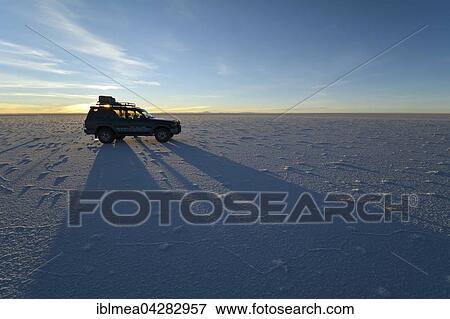 SUV shadow on salt flat, sunrise, Salar de Uyuni, Bolivia, South America View Large Photo Image Stock Photo - SUV shadow on salt flat, sunrise, Salar de Uyuni, Bolivia, South America. Fotosearch