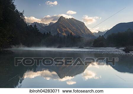 Svinjak Mountain reflected in Soca, Soca Valley, Triglav National Park, Slovenia, Europe View Large Photo Image Stock Image - Svinjak Mountain reflected in Soca, Soca Valley, Triglav National Park, Slovenia, Europe. Fotosearch
