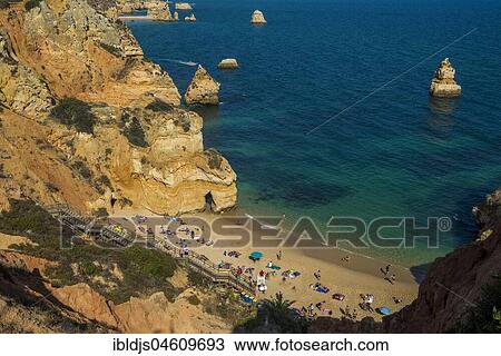 Swimmers on the beach between steep cliffs, Praia do Camilo, Lagos, Algarve, Portugal, Europe View Large Photo Image Stock Image - Swimmers on the beach between steep cliffs, Praia do Camilo, Lagos, Algarve, Portugal, Europe. Fotosearch
