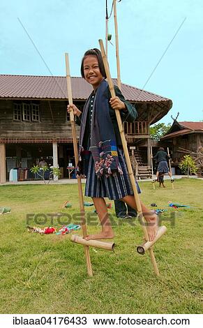 Tai Dam children walking on bamboo stilts, Loei province, Thailand, Asia View Large Photo Image Stock Image - Tai Dam children walking on bamboo stilts, Loei province, Thailand, Asia. Fotosearch