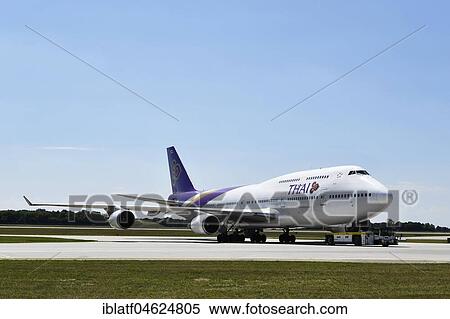 Thai Airways, Boeing B747-400, towing with a tug, Munich Airport, Upper Bavaria, Germany, Europe View Large Photo Image Stock Photography - Thai Airways, Boeing B747-400, towing with a tug, Munich Airport, Upper Bavaria, Germany, Europe. Fotosearch