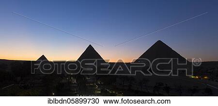 Stock Image - The three main pyramids at sunset, Giza, Egypt, Africa. Fotosearch