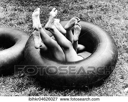Three children playing in one innertube ca. 1970s, exact place unknown, Czech Republic, Europe View Large Photo Image Stock Photo - Three children playing in one innertube ca. 1970s, exact place unknown, Czech Republic, Europe. Fotosearch