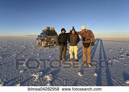 Three men and SUV on salt flat, Salar de Uyuni, Altiplano, Bolivia, South America View Large Photo Image Stock Photo - Three men and SUV on salt flat, Salar de Uyuni, Altiplano, Bolivia, South America. Fotosearch