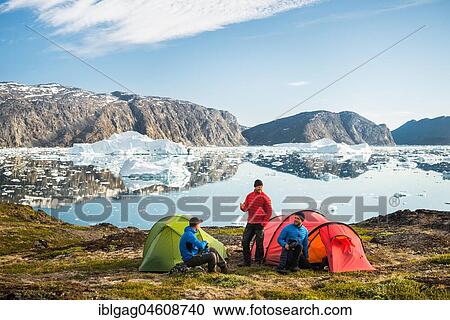Three people with tents, red and green, mountains, fjord with icebergs, Greenland, North America View Large Photo Image Stock Image - Three people with tents, red and green, mountains, fjord with icebergs, Greenland, North America. Fotosearch