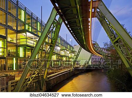 Stock Photo - Traces of light from a moving suspension railway over the river Wupper, Dämmerung, Wuppertal, Bergisches Land, North Rhine-Westphalia, Germany, Europe. Fotosearch