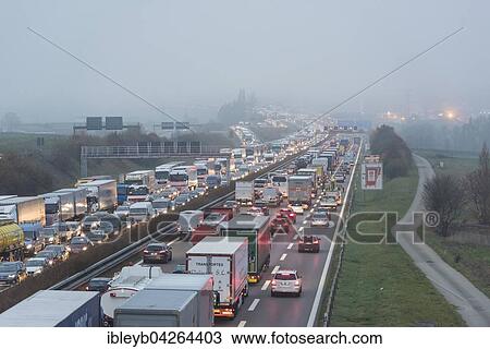 Stock Image - Traffic jam on the A8 in fog, near Stuttgart, Baden-Wurttemberg, Germany, Europe. Fotosearch