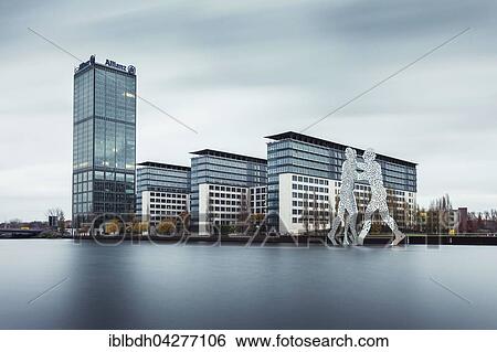 Stock Photograph - Treptowers with Allianz Tower by the River Spree, Molecule Man sculpture by the artist Jonathan Borofsky, Treptow, Berlin, Germany, Europe. Fotosearch