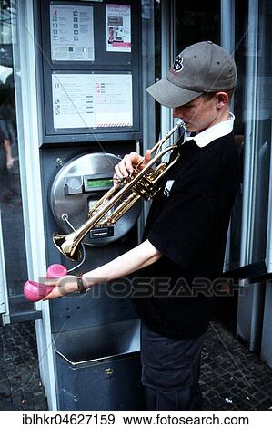 Stock Photo - Trumpet player in the telephone booth, Berlin, Germany, Europe. Fotosearch