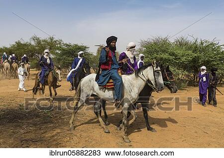 Stock Image - Tuaregs on their camels, Gerewol festival, courtship ritual competition among the Woodaabe Fula people, Niger, Africa. Fotosearch