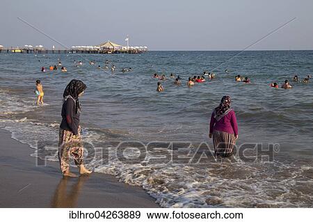 Turkish women bathing in the sea, with clothes, Side-Sorgun, Side Belediyesi, Turkish Riviera, Antalya, Turkey, Asia View Large Photo Image Stock Photo - Turkish women bathing in the sea, with clothes, Side-Sorgun, Side Belediyesi, Turkish Riviera, Antalya, Turkey, Asia. Fotosearch